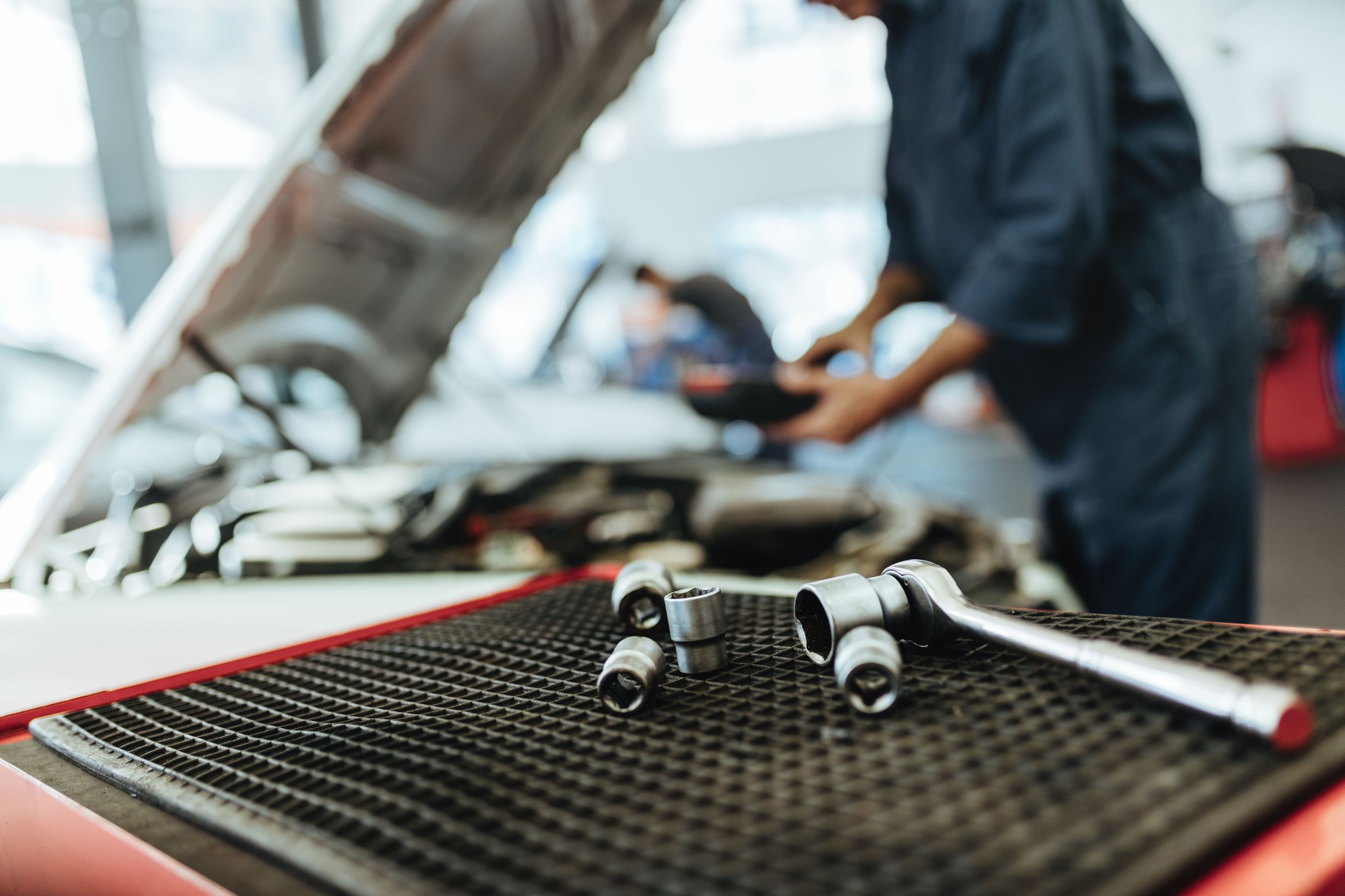 Ratchet spanner and sockets in car workshop